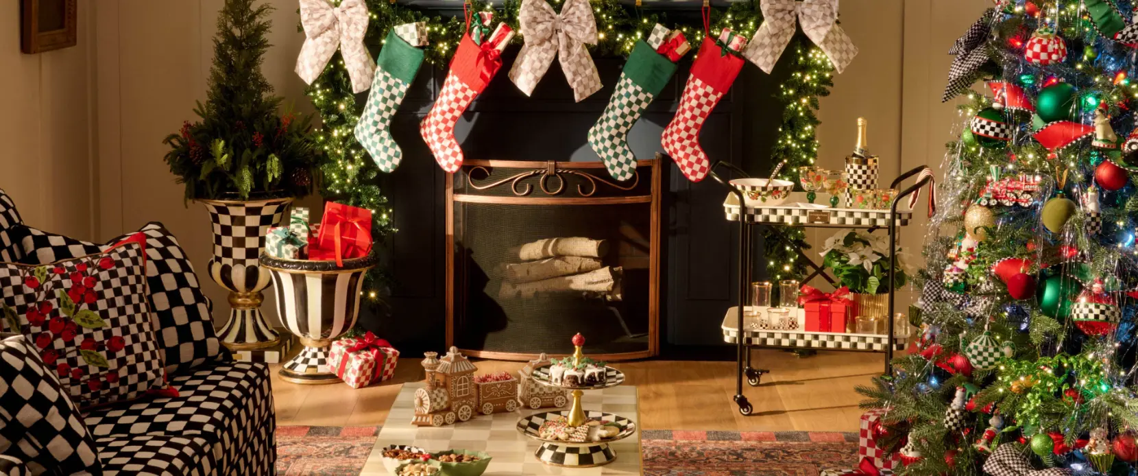 MacKenzie-Childs Christmas living room with stockings on the mantel and a decorated tree