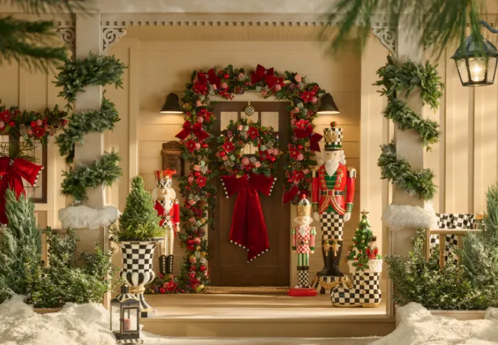 Front porch with a Christmas wreath and MacKenzie-Childs nutcrackers