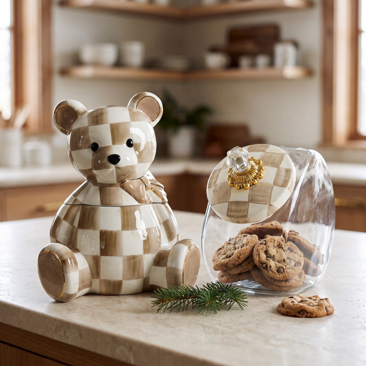MacKenzie-Childs Mocha Bear cookie jar next to the shorter glass cookie jar with Mocha Check lid on a cream kitchen counter